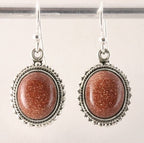 Bewerkte ovale zilveren oorbellen met goudsteen afbeelding 1