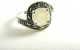 21138 Zilveren ring met regenboog maansteen en marcasiet - maat 17