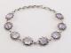 31446 Bewerkte zilveren schakelarmband met amethist
